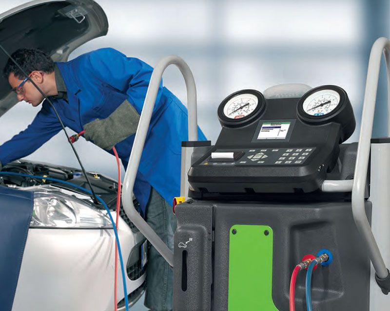 Professional tow truck operator securing a luxury vehicle for transport